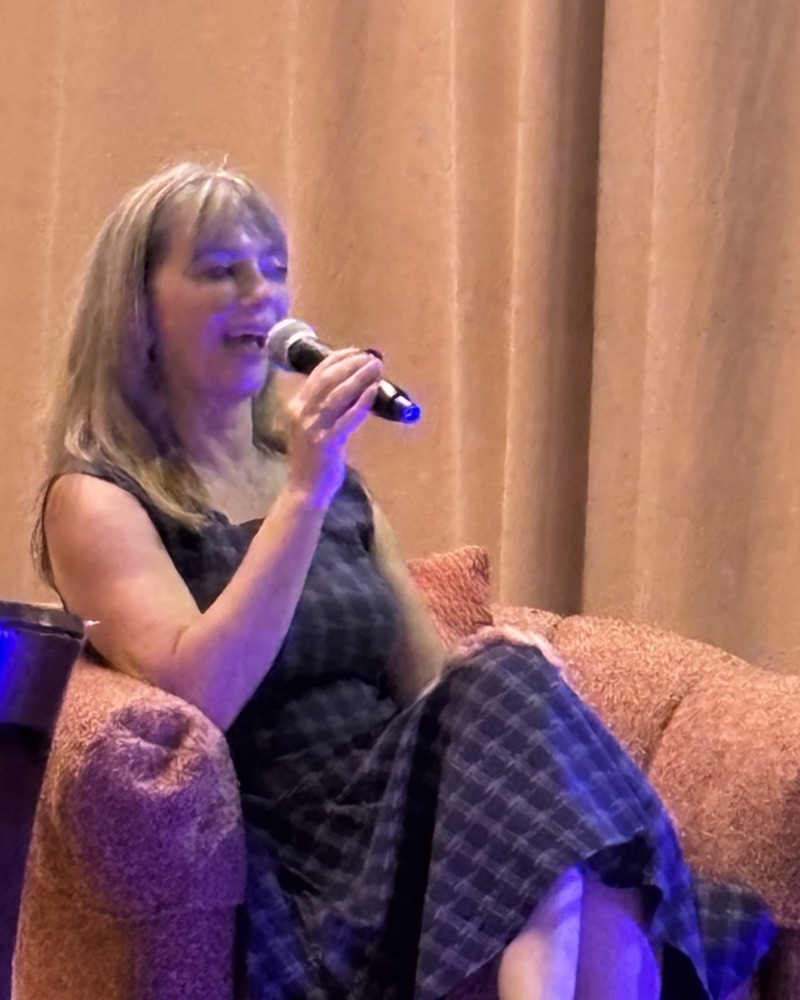 Kimberly Berg speaking on stage